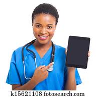 african american nurse pointing tablet computer