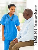 african medical doctor talking to senior man 