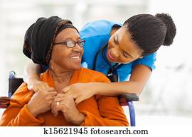 african senior patient with female nurse