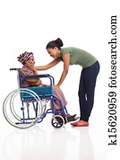 african woman comforting disabled senior grandmother