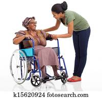 african woman talking to disabled senior mother