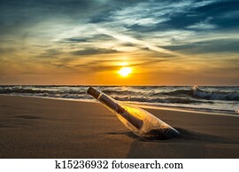Ancient message in a bottle on a sea shore