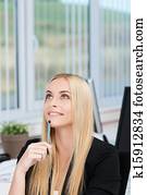 Attractive businesswoman sitting thinking