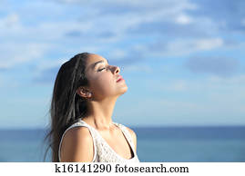 Beautiful arab woman breathing fresh air in the beach