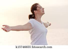 beautiful girl enjoying her freedom with open arms