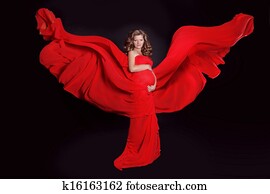 Beautiful Pregnant woman with red blowing tissue isolated on black background. Fairy.