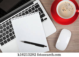 Blank notepad over laptop and coffee cup