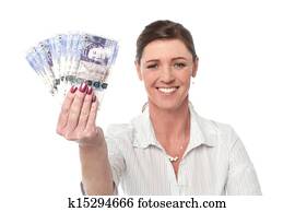 Business woman holding fan of currency notes