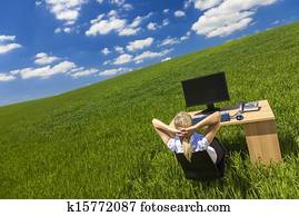 Business Woman Relaxing at Desk in Green Field Office