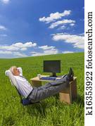 Businessman Relaxing Feet Up Desk in Green Field