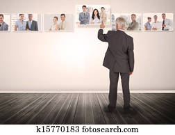 Businessman selecting business people digital interface