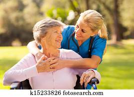 caring nurse with senior patient