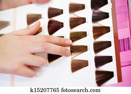 Client's Hand Choosing Color From Hair Samples