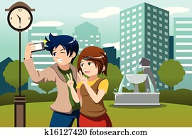 Couple on vacation taking picture of themselves with their cellphone Couple on vacation taking picture of themselves with their cellphone