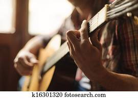 Creativity in focus. Close-up of man playing acoustic guitar Creativity in focus. Close-up of man playing acoustic guitar
