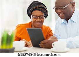 elderly african couple using tablet computer