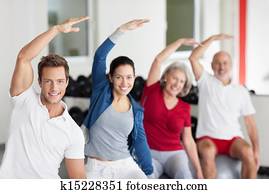 Enthusiastic group doing aerobics at a gym Enthusiastic group doing aerobics at a gym