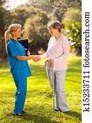 female nurse greeting recovering senior patient