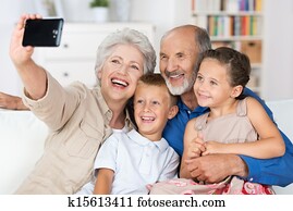 Grandparents and grandchildren with a camera