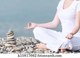 hand of  woman meditating in a yoga pose on beach