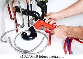 Hands of Plumber with a wrench. Hands of Plumber with a wrench.