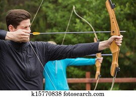 Handsome man practicing archery