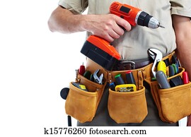 Handyman with a tool belt and drill. Handyman with a tool belt and drill.