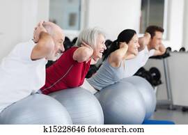 Happy Family Exercising On Swiss Ball Happy Family Exercising On Swiss Ball