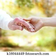 Holding hands with senior Holding hands with senior