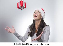 Laughing woman catching a surprise Christmas gift