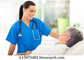 medical nurse talking to senior patient