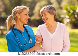 nurse talking to senior woman outdoors nurse talking to senior woman outdoors