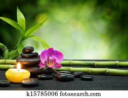 purple orchid, candle, with stones purple orchid, candle, with stones