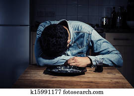 Sad man alone in his kitchen