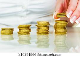save woman with stack of coins on money save woman with stack of coins on money