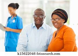 senior african couple in doctors office