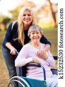 senior woman in a wheelchair and her daugther