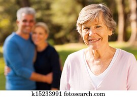 senior woman in front of middle aged son and daughter-in-law senior woman in front of middle aged son and daughter-in-law