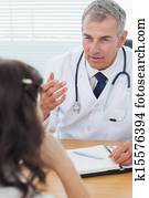 Serious doctor talking to his patient