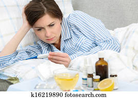 Sick woman lying in bed