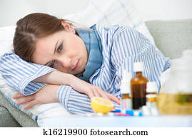 Sick woman lying in bed