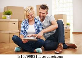 Smiling couple buying new furniture for their home Smiling couple buying new furniture for their home