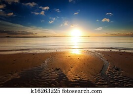 Sunrise sea beach sky landscape. Beautiful sun light reflection in ocean water nature background Sunrise sea beach sky landscape. Beautiful sun light reflection in ocean water nature background
