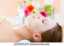 Wellness - woman getting face mask in spa