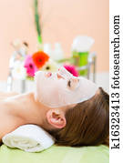 Wellness - woman getting face mask in spa