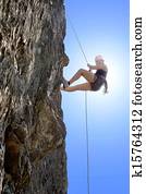 Woman Climbing Rock