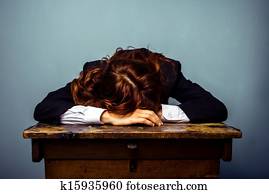 Woman in suit sleeping on podium