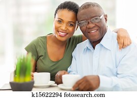 young adult african woman and father having coffee