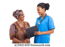 young african nurse helping senior woman with medical form