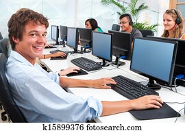 Young student working on computer in office.